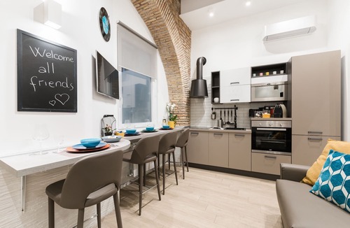 Trastevere Apartment | 17th-century apartment with beams and arches in Trastevere's iconic alley