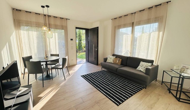 Elegant newly built apartment, located on the ground floor. Internally it consists of entrance on living room and kitchenette, double bedroom, twin bedroom, two bathrooms with shower. To complete the property large private garden and double outdoor parki