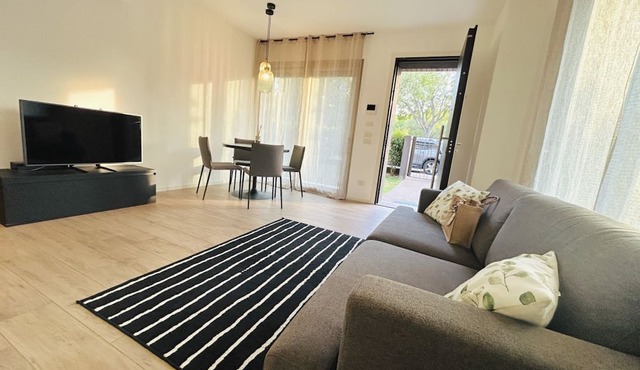 Elegant newly built apartment, located on the ground floor. Internally it consists of entrance on living room and kitchenette, double bedroom, twin bedroom, two bathrooms with shower. To complete the property large private garden and double outdoor parki